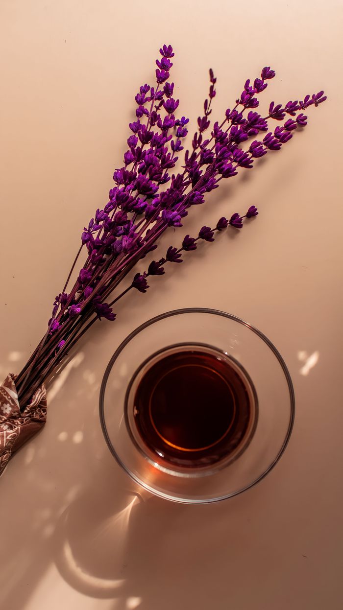 Top view of a glass of tea with lavender, creating a calming and aromatic atmosphere.